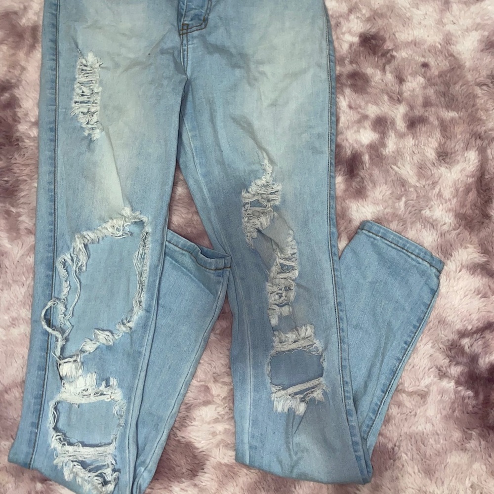 Distressed light blue jeans